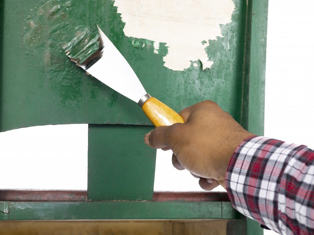 scraping old green paint