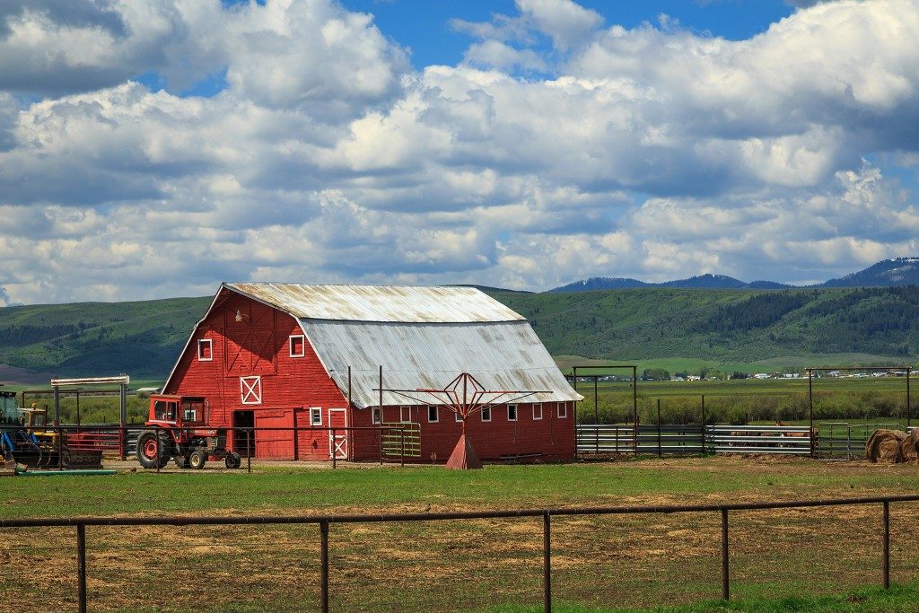 red barn surrounded by mountains