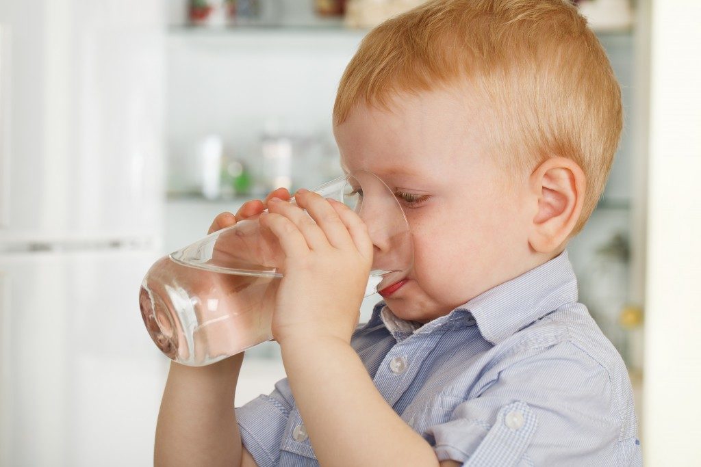 Boy drinking water from a glass