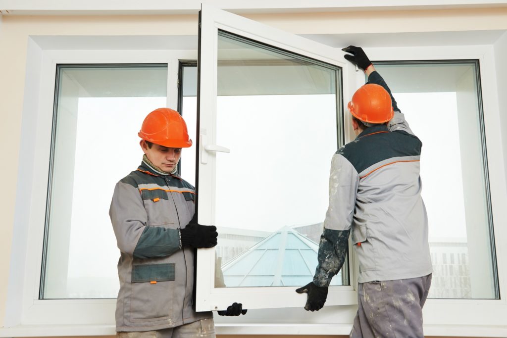 two men installing window glasses