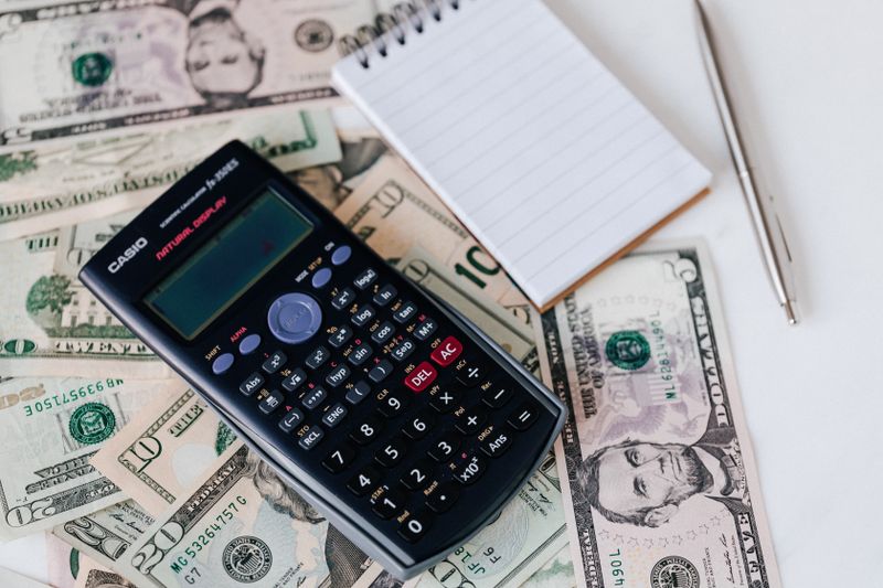 a calculator, a notebook, and some cash